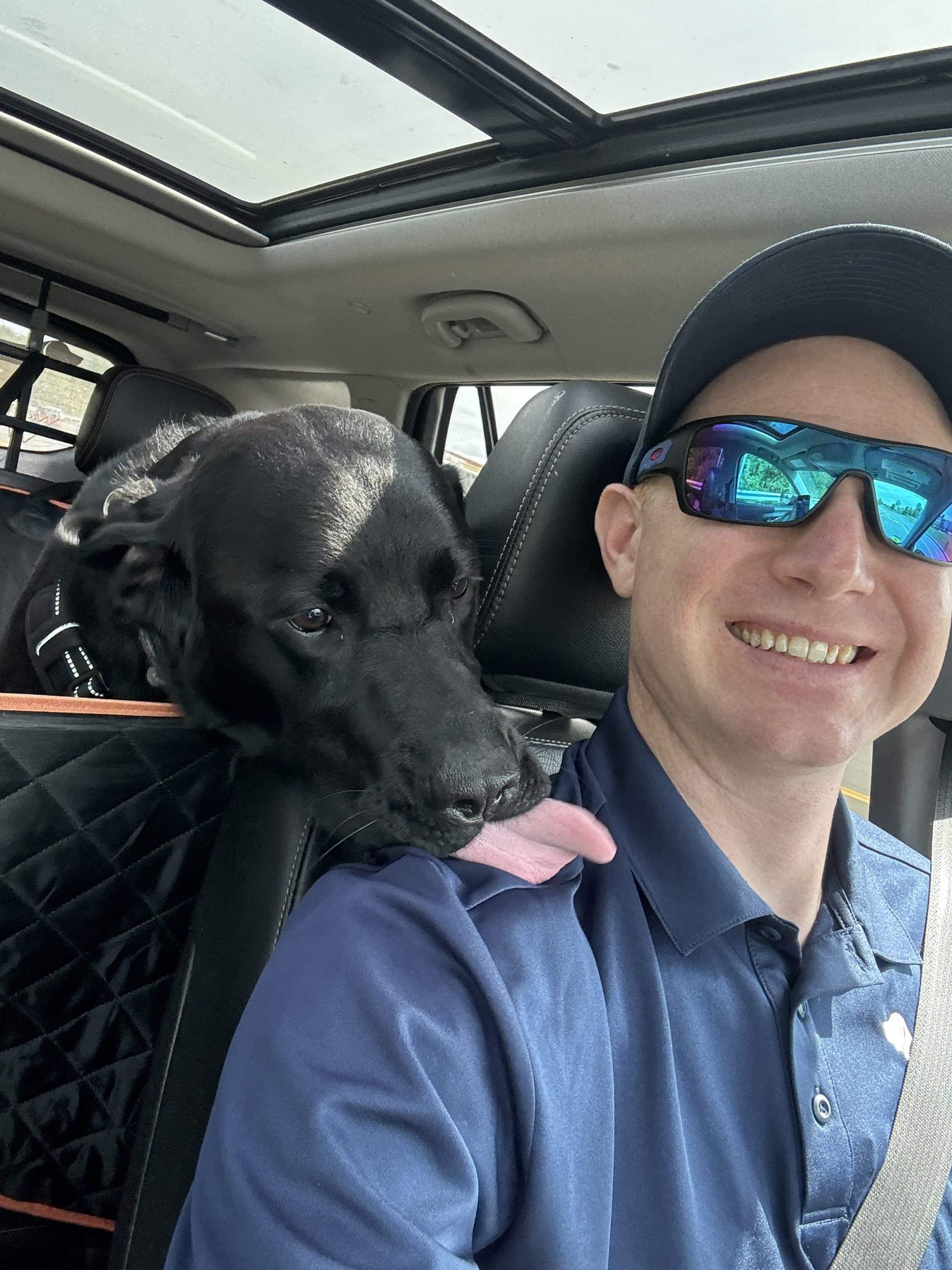 Jakob with a client dog on a Wag & Wheels transport ride